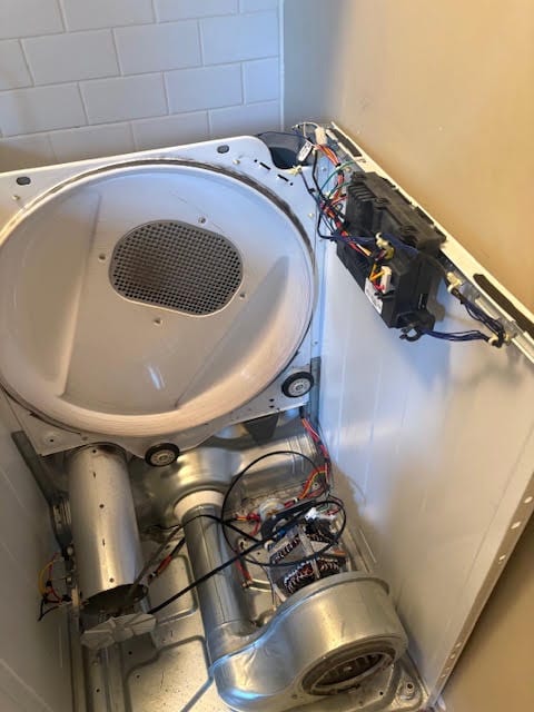 Dryer opened for access to the drum, blower and internal wiring